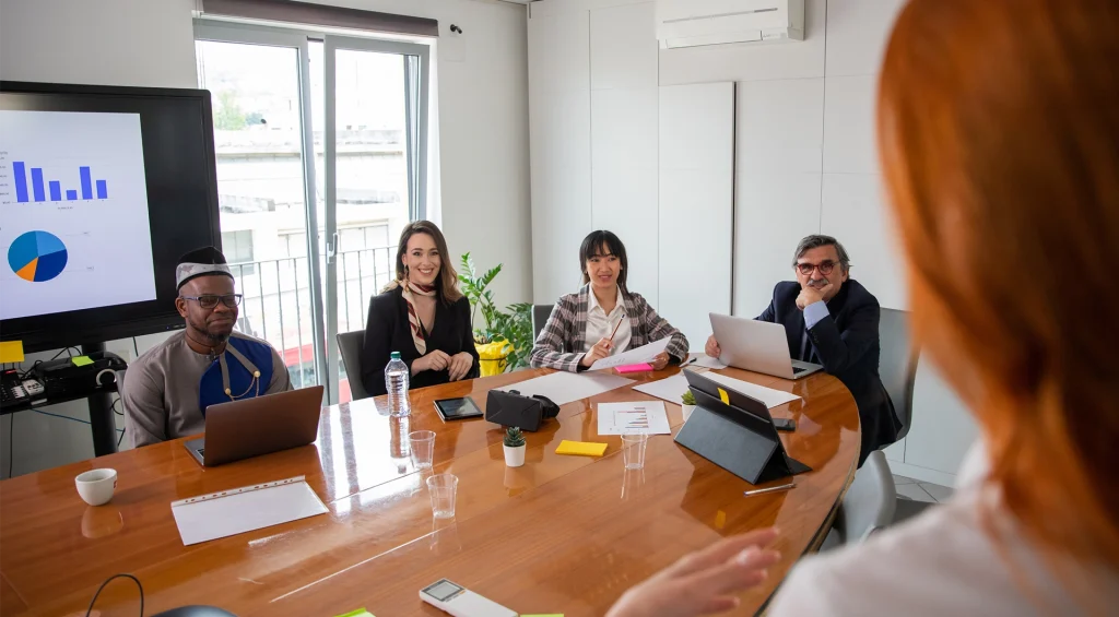 Small group of business people meeting at a conference table