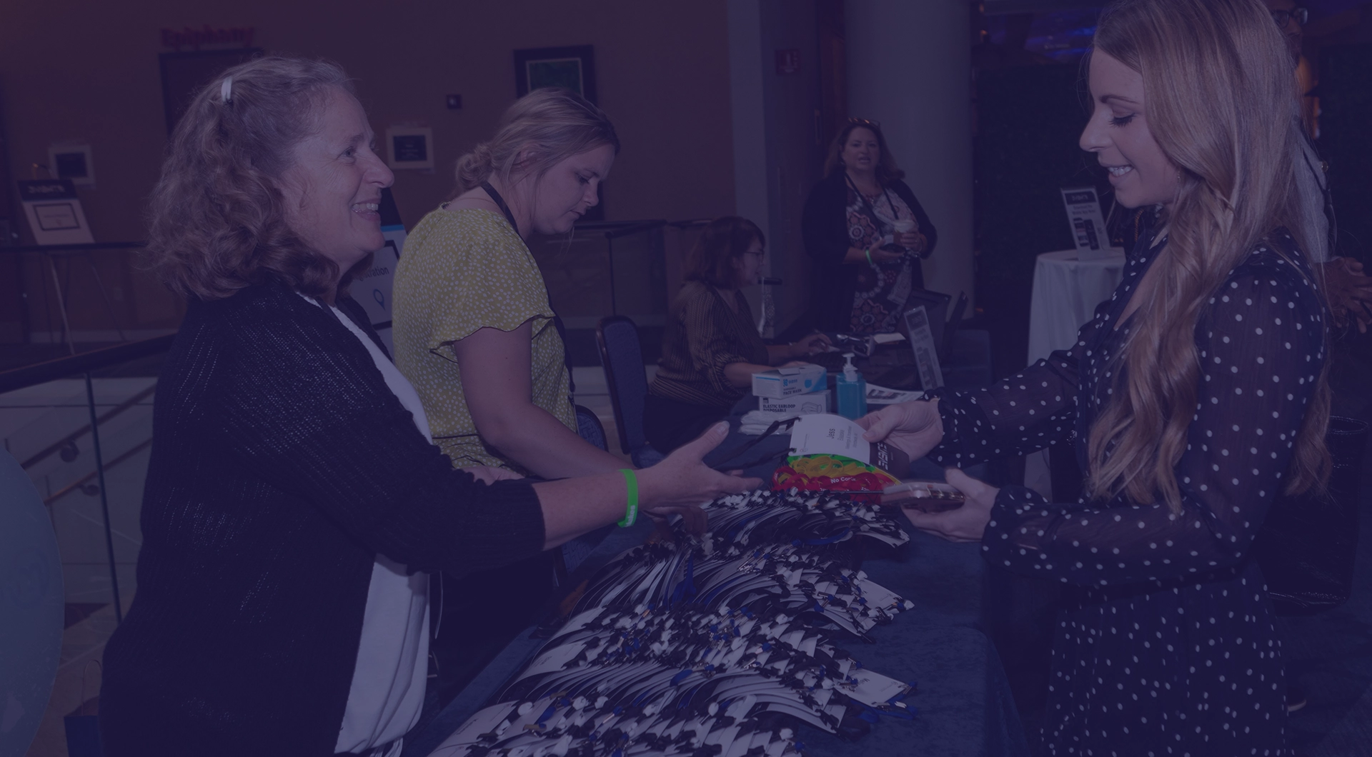 Attendees checking in at registration table