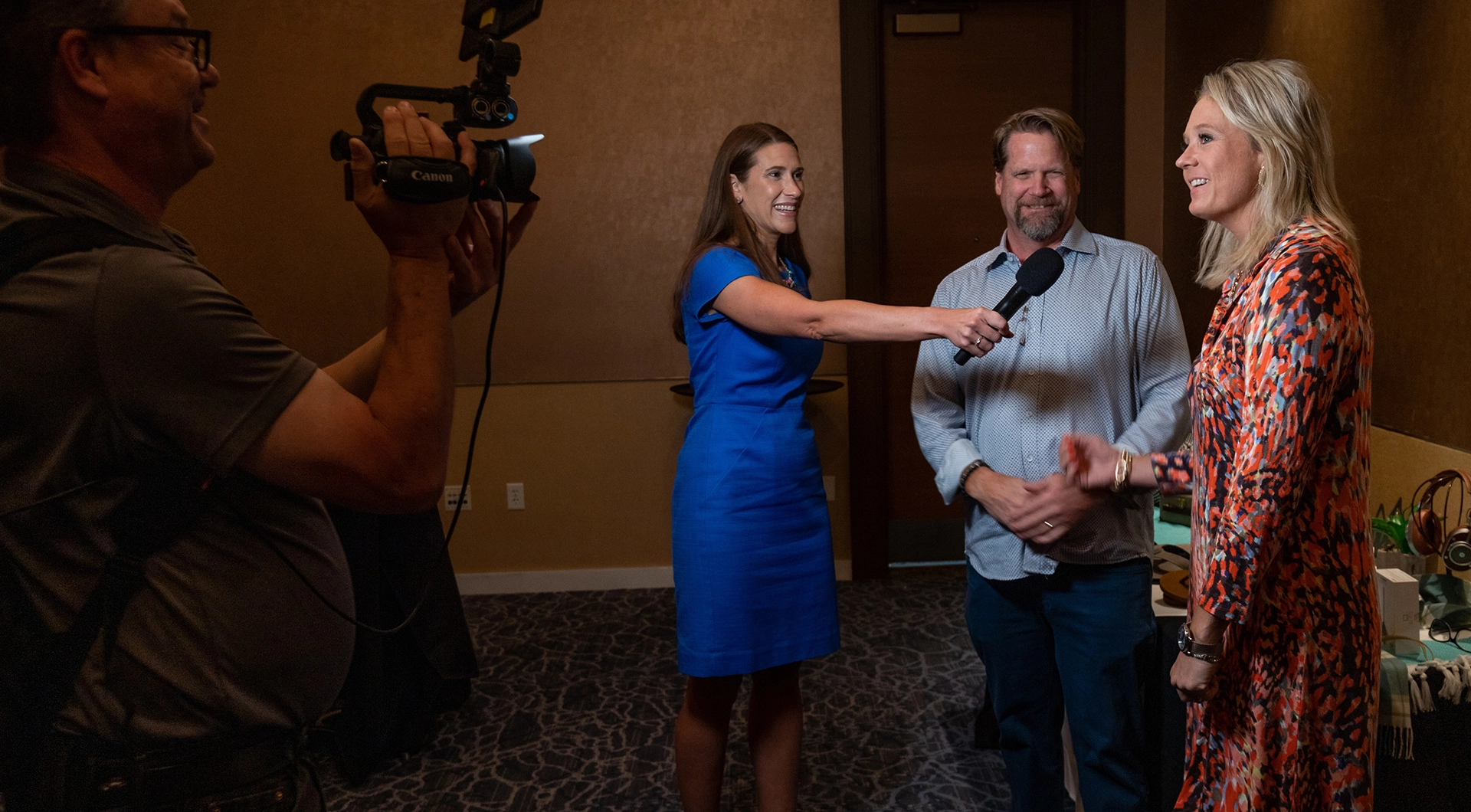 Man and woman being interviewed on camera