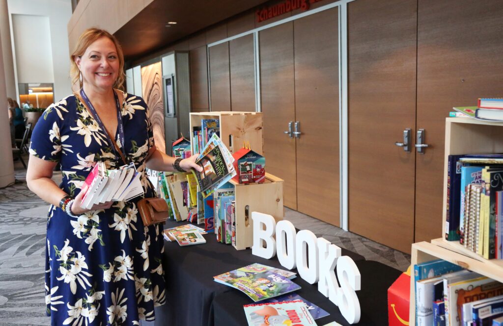 An attendee donates books at the 2024 M&IW Summit