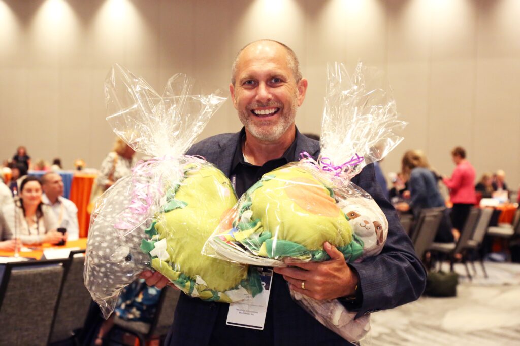 An attendee holds care packages made at the 2024 M&IW Summit