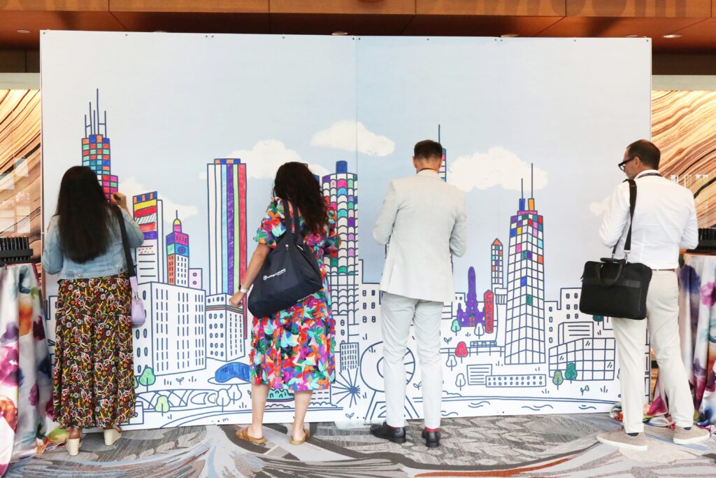 Attendees color at a coloring wall at the 2024 M&IW Summit