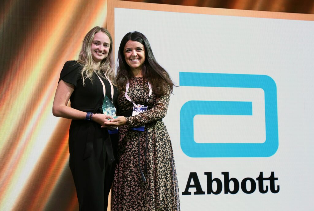 Emily Schmidt and Joana Araujo accepting the Moxie Award for Abbott