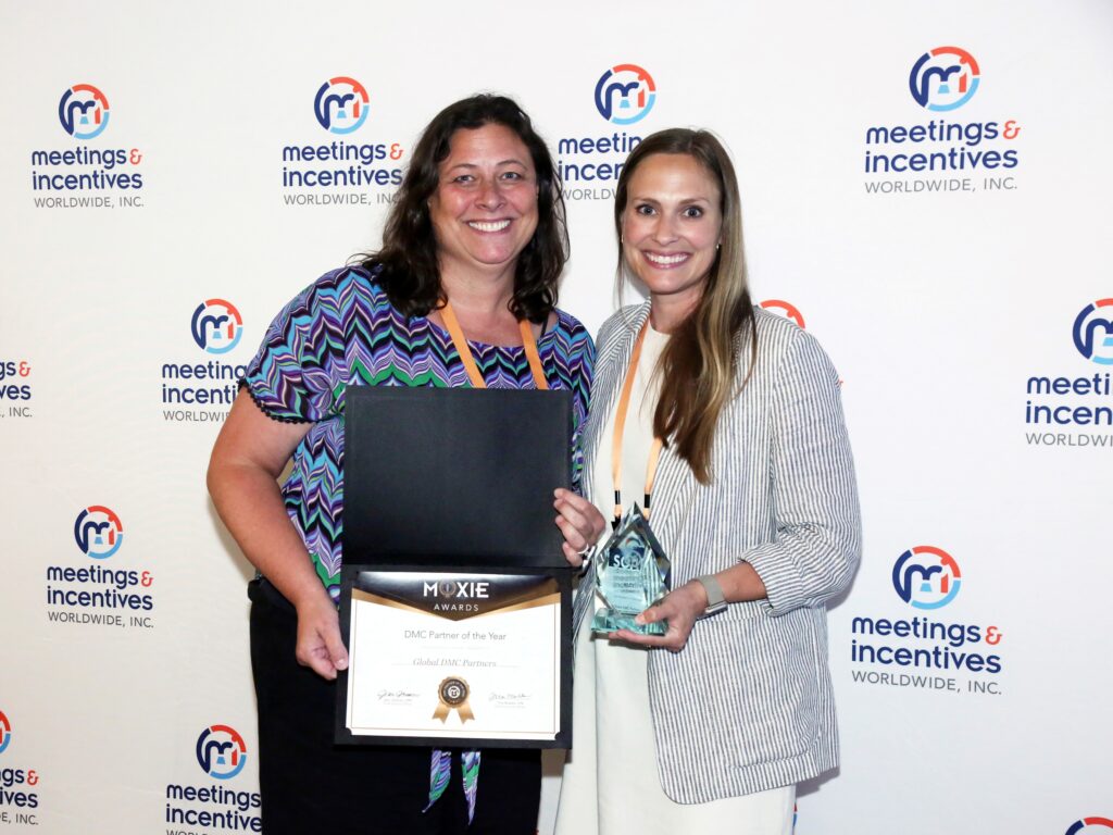 Dawn Barbeau and Riley Sassano accepting the Moxie Award for Global DMC Partners