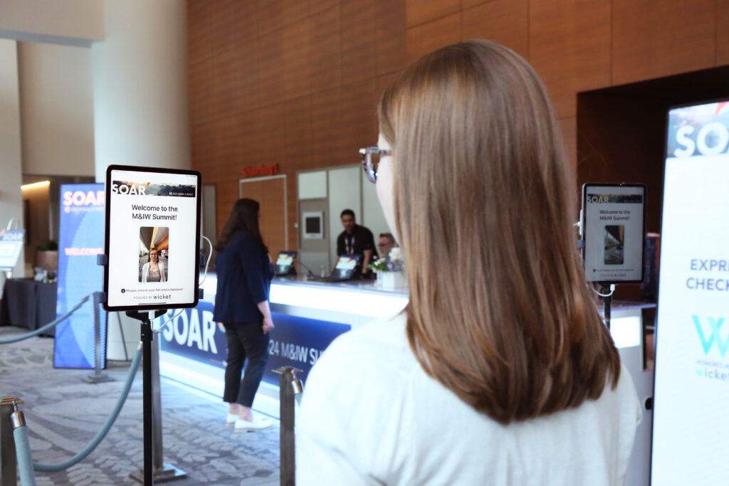 An attendee uses express check-in at the 2024 M&IW Summit