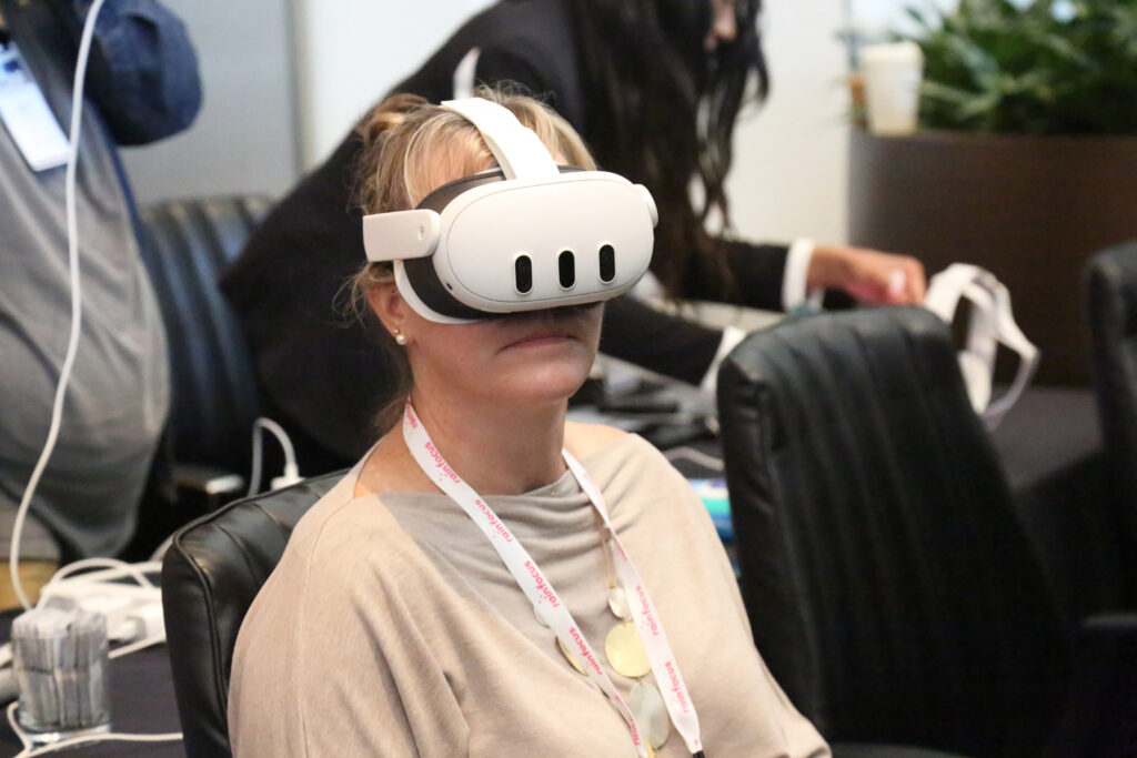 An attendee wears a virtual reality headset at the 2024 M&IW Summit