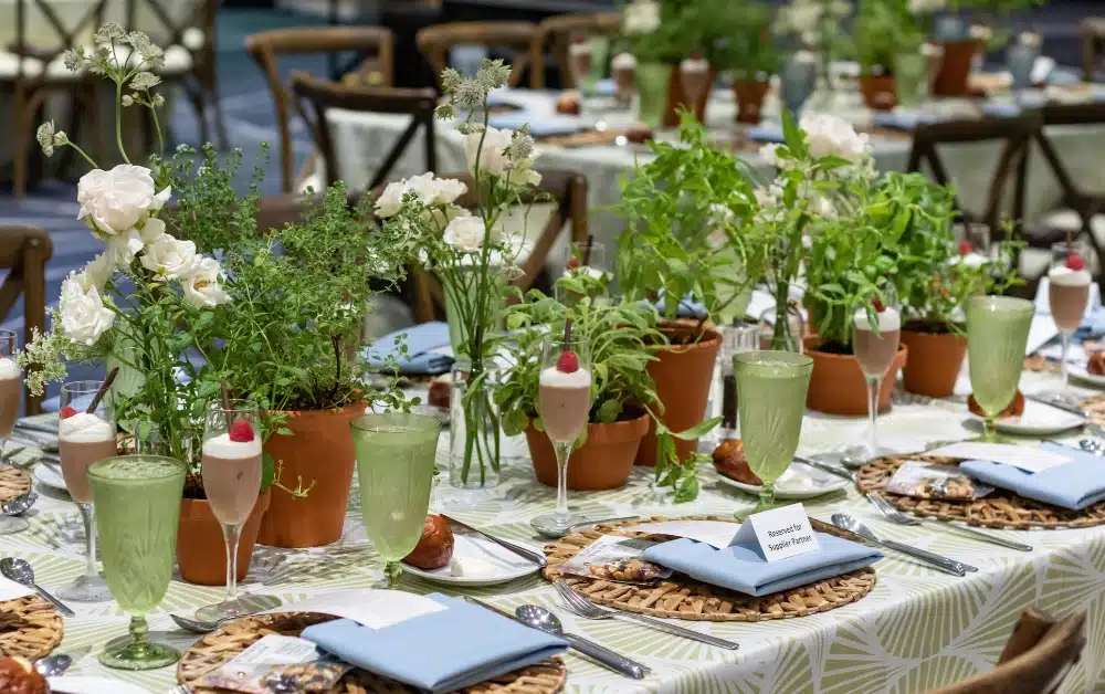 An event meal with fresh herbs used as centerpieces