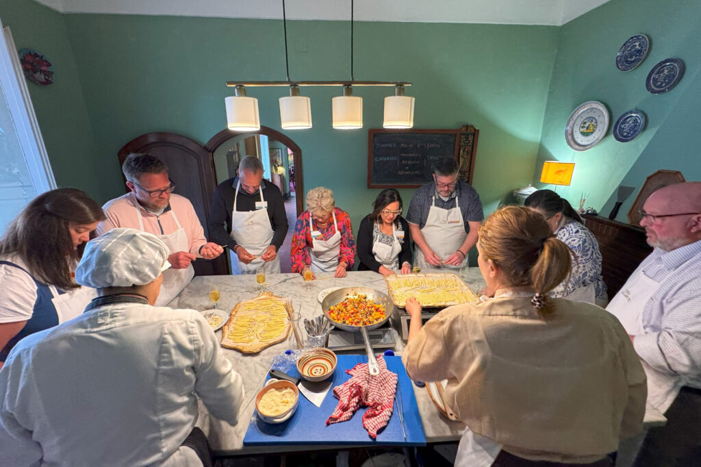 Incentive trip attendees participating in a pasta-making class