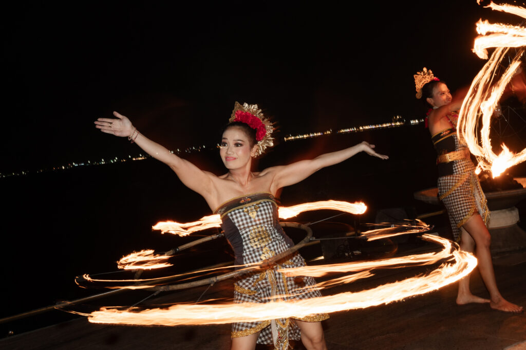 Fire dancer twirling flaming hula hoops