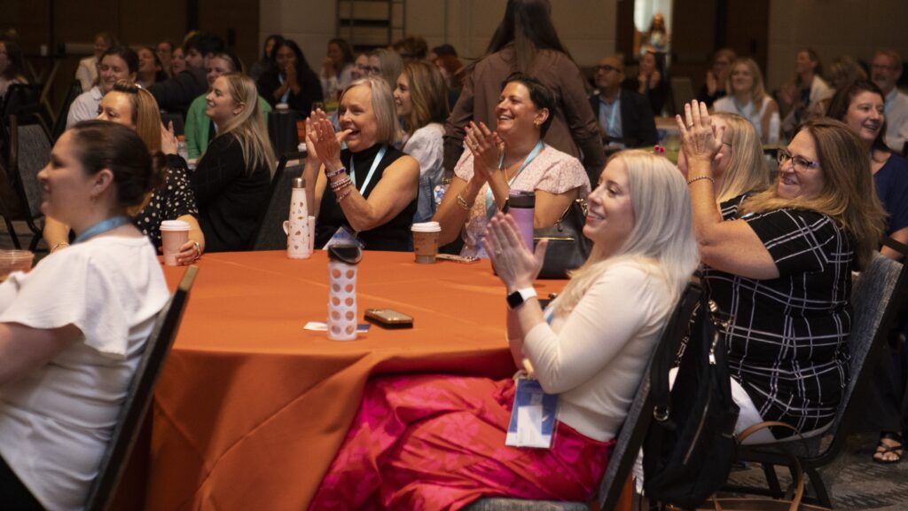Audience members applauding at the 2025 M&IW Summit
