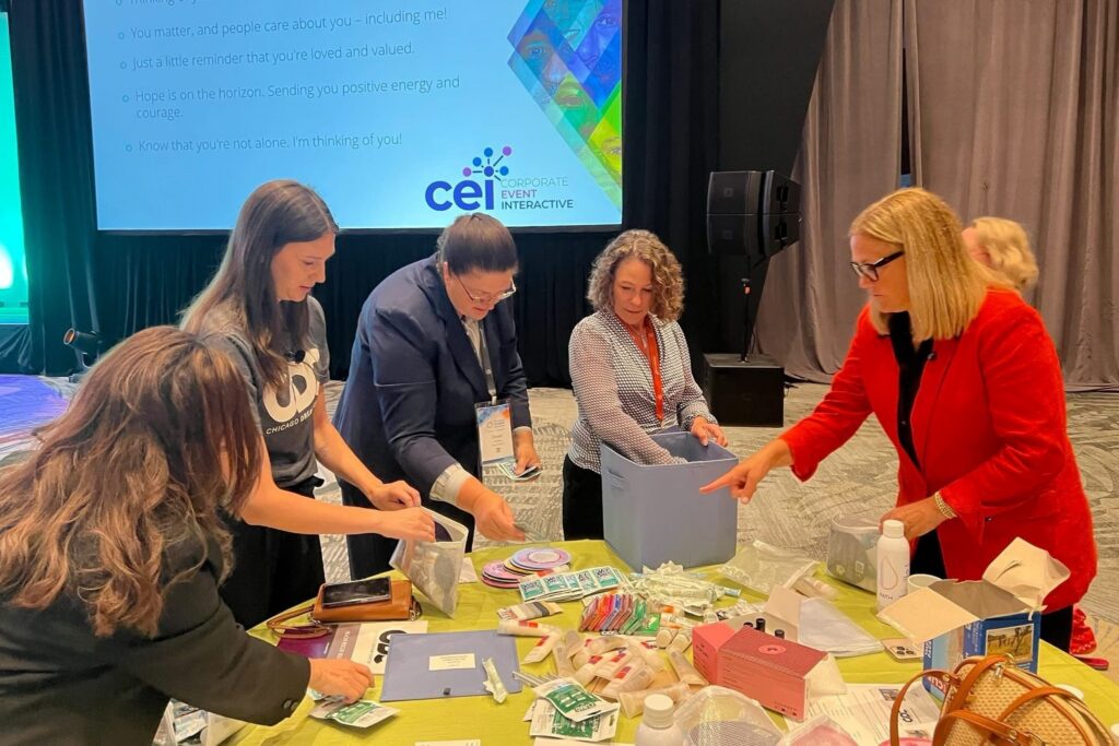 M&IW CEO Tina Madden, right, and other attendees participate in a CSR activity at the 2025 M&IW Summit