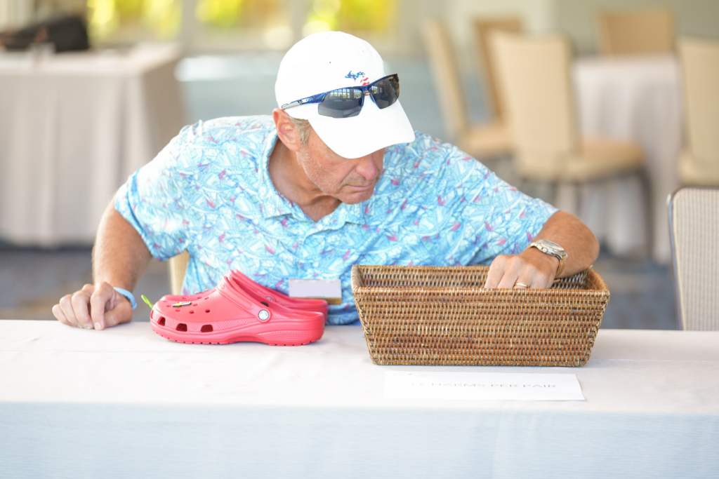 Attendee decorating a pair of Crocs