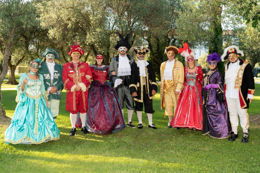 Attendees pose in costumes and masks at the masquerade awards gala