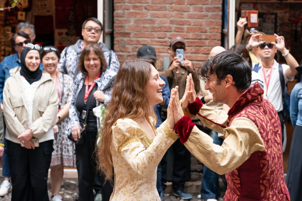 Attendees watch actors perform Romeo & Juliet in Verona